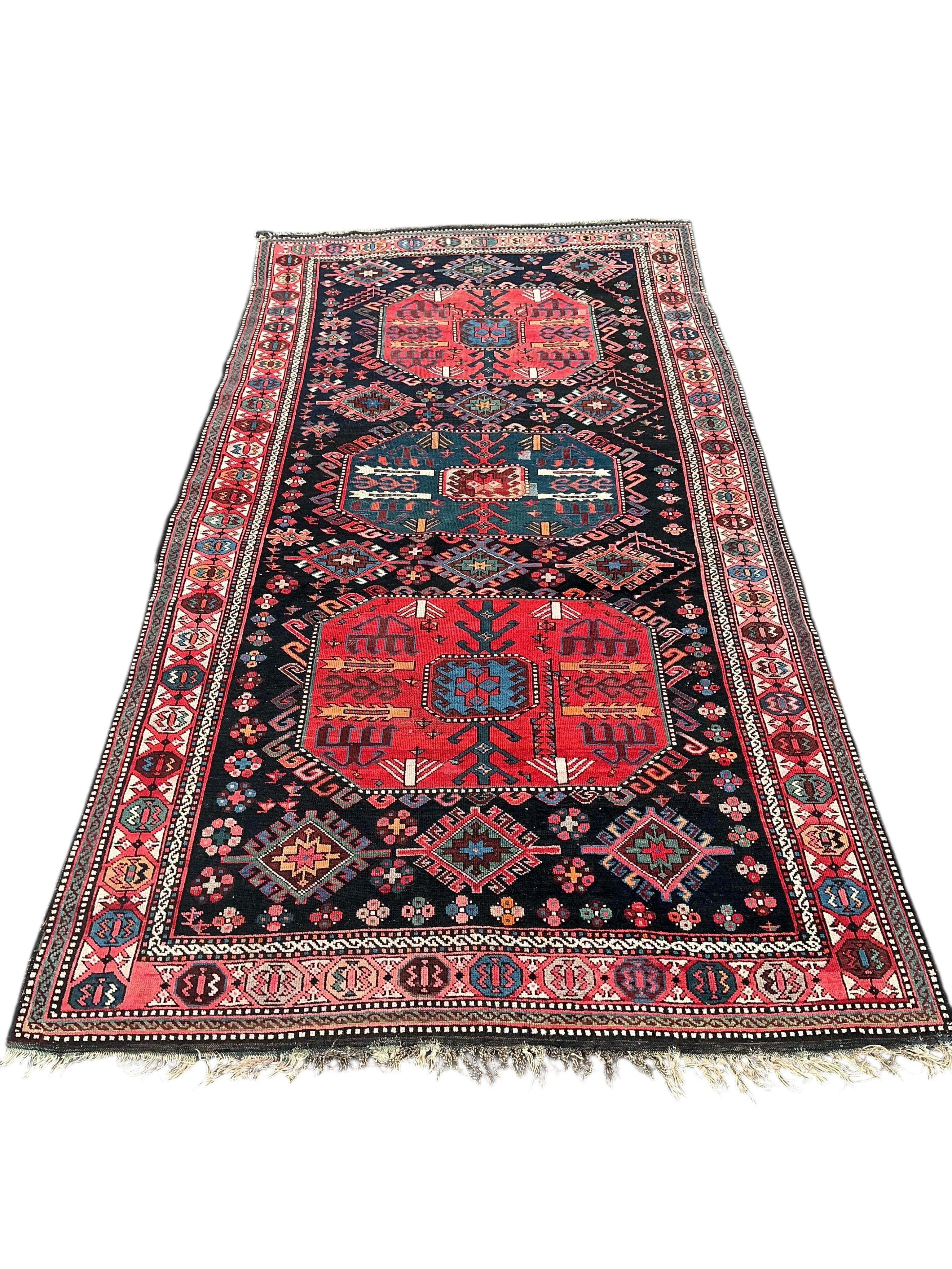 An antique Caucasian blue ground rug, 280 x 140cm